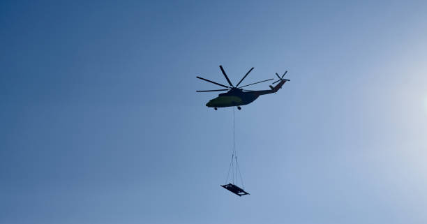 istock The world's largest cargo helicopter hovers overhead. Bottom view.The world's largest cargo helicopter transports cargo on a wire rope. Bottom view 1363494844
