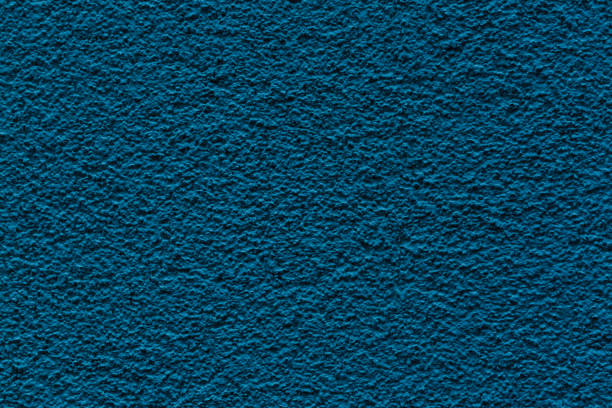 istock Sample of a texture of blue plaster. Wall finished with a decorative cement stucco. Example of exterior building decoration. Clean uniform grainy background. Banner. Wallpaper. Copy space. Pattern 1363496262