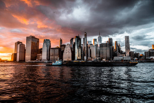 Famous Manhattan cityscape seen from the Brooklyn Heights with numerous skyscrapers during an enchanting sunset.