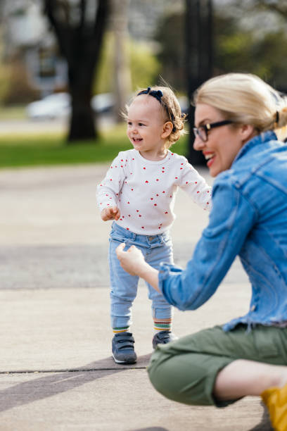 istock Adorable Girl Playing Outside With Her Anonymous Mom 1363504970