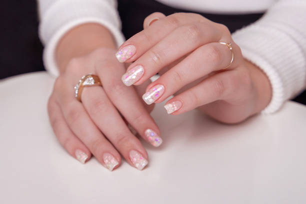 istock Female hands with festive manicure nails 1363505071