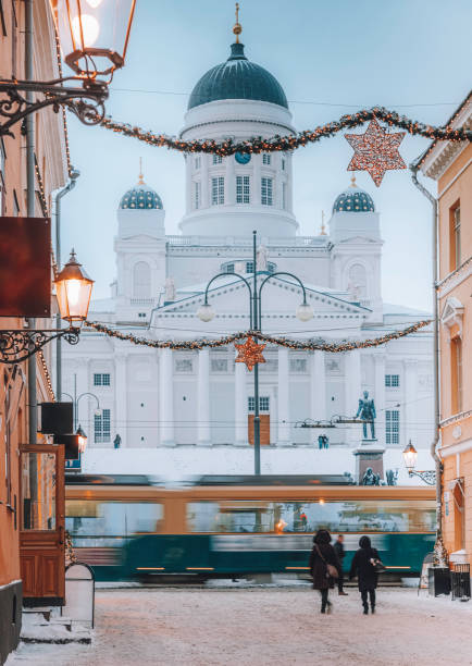 Senat Square and The Lutheran Cathedral in the snowy winter morning time from the illuminated street and tram on Christmas time. Helsingin tuomiokirkko (Suurkirkko)