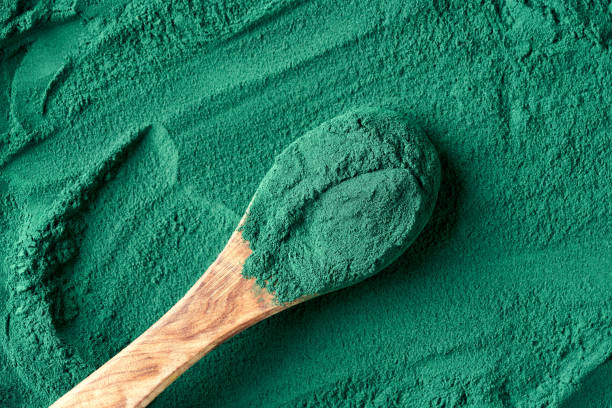 istock Spirulina algae powder on a spoon, top view 1363506732