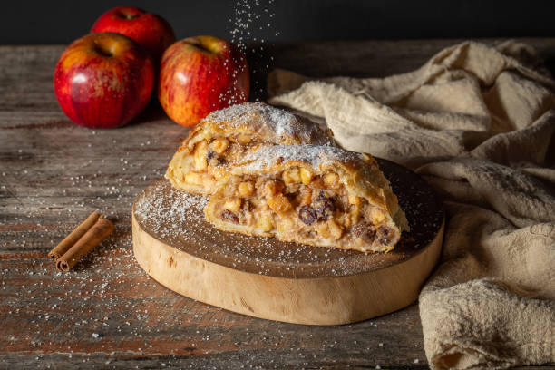 apple strudel with cinnamon and raisins  sprinkling powdered sugar on top. Austrian food from Germany. apple strudel with cinnamon and raisins  sprinkling powdered sugar on top. Austrian food from Germany. apple strudel stock pictures, royalty-free photos & images