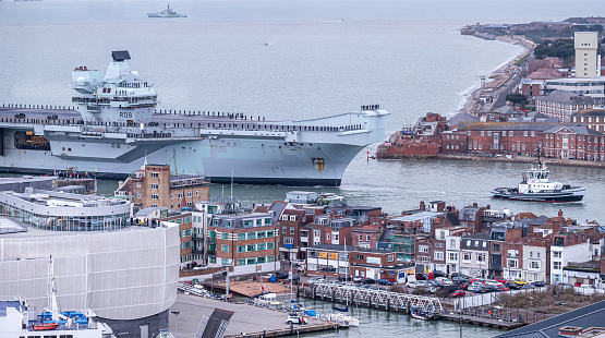 Aircraft carrier HMS Queen Elizabeth of the Royal Navy returns to Portsmouth Harbor from her maiden deployment to Asia and the Far East on which she lost a £100m jet, tangled with the Russian navy and survived a covid outbreak,