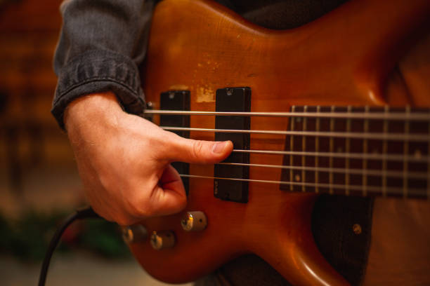 istock A young guy with a beard plays a bass guitar with five strings 1363511403