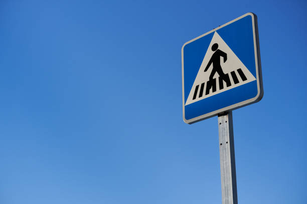 traffic signal pedestrian crossing over blue sky