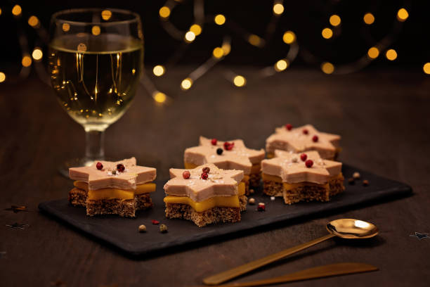 Foie gras, goose liver toasts with mango and ginger bread star shaped. Traditional french starter for winter holidays celebration. Cristmas appetizer for buffet, festive dinner concept foie gras stock pictures, royalty-free photos & images