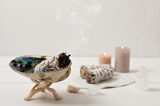 Smudge kit with white sage stick, abalone sea shell. Natural elements for cleansing environment from negative energy, adding positive vibes. Spriritual practices, witchcraft concept