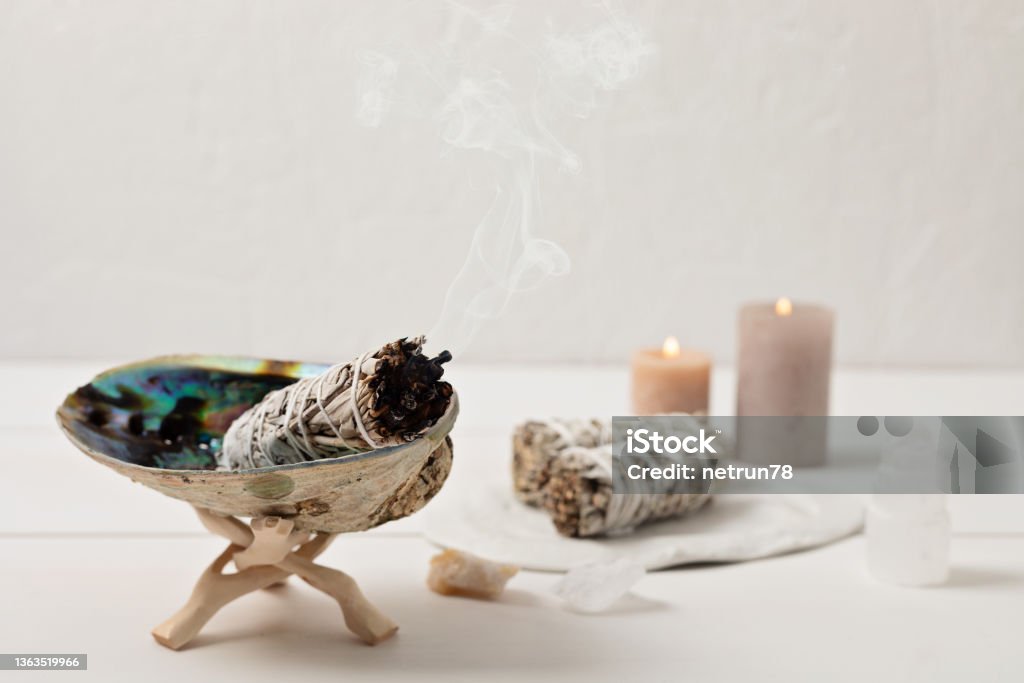 Smudge kit with white sage stick, abalone sea shell. Natural elements for cleansing negative energy Smudge kit with white sage stick, abalone sea shell. Natural elements for cleansing environment from negative energy, adding positive vibes. Spriritual practices, witchcraft concept Zen-like Stock Photo