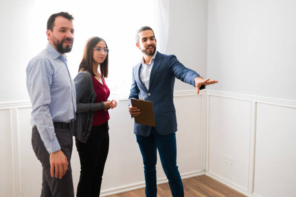 istock Professional Real Estate Agent showing a house 1363521561