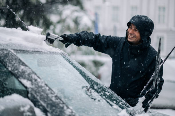 istock Middle aged man cleaning car from snow and ice 1363522647