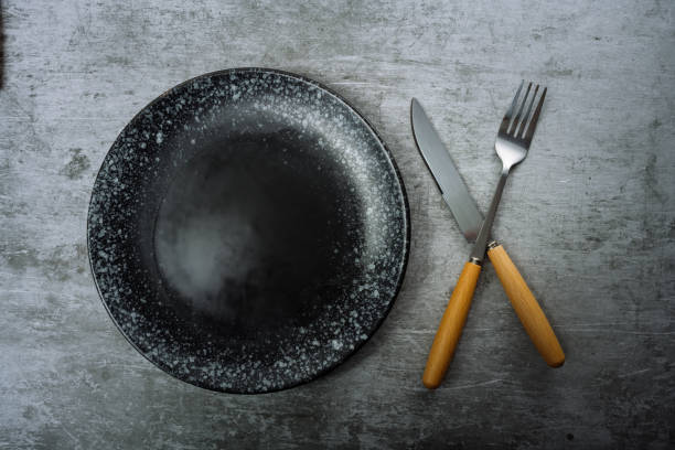 istock Knives, forks and plates on marble slabs 1363526944