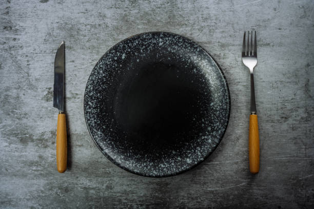 istock Knives, forks and plates on marble slabs 1363526947