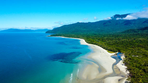 The rainforest meets the reef Aerial view of the Daintree Rainforest sweeping down to meet the Great Barrier Reef in Cape Tribulation, QLD great barrier reef marine park stock pictures, royalty-free photos & images