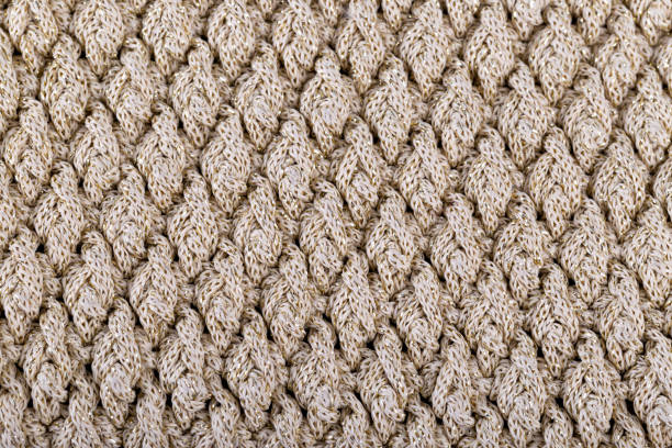 istock Texture of beige knitted woollen fabric 1363538098
