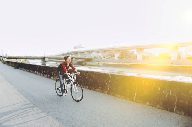istock Asian woman riding a bicycle 1363541735