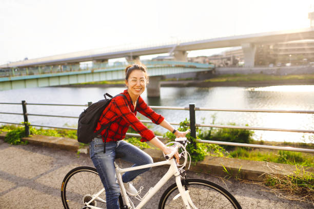 istock Asian woman riding a bicycle 1363541736