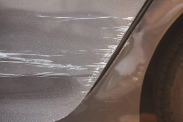 istock Silver blonde door car has a scratch in a long line and see a white color inside it 1363545317