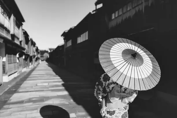 Photo of woman in a kimono walking in the Higashi Chaya district of Kanazawa, Japan