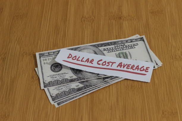 istock Conceptual Photo, Stack Randomly Money paperand text Dollar Cost Average, or DCA golden rule investment 1363545390