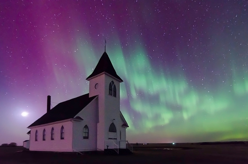 Aurora Borealis Northern Lights over the historic St. John's Lutheran Church established in 1919 near Cabri, Saskatchewan, Canada