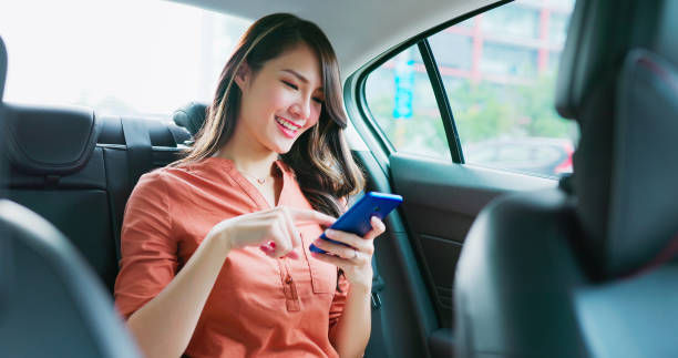 istock businesswoman use phone in car 1363552216