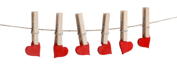 Clothes pegs and red hearts on rope