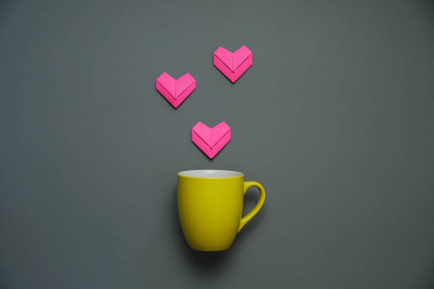 istock pink heart paper art on a coffee cup. 1363558183