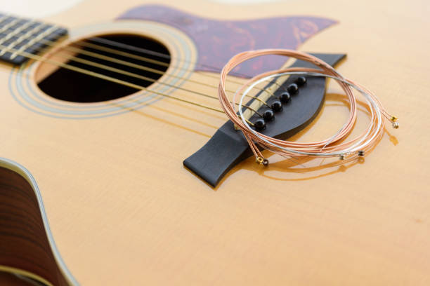 istock The musician replace the new guitar strings for his guitar 1363559748