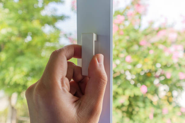 istock Hand hold mosquito net wire screen handle on house window 1363566817