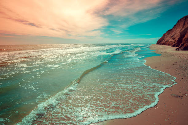 Seascape with clay steep coast. Seashore on a cloudy day