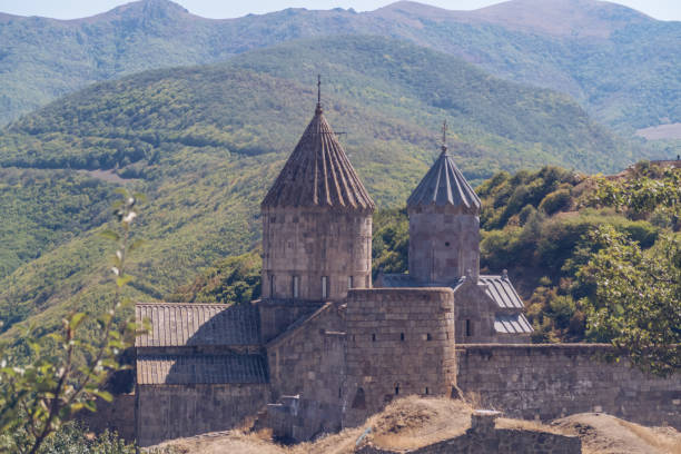 Scenic Tatev monastery view in Armenia. Ancient church ruins. Armenian landscape of Tatev monastery complex surrounded by green mountains and lush green hills stock photography stock photo
