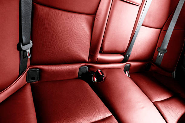 istock Back passenger red seats in modern luxury car. Red perforated leather with white stitching. Car detailing. Leather comfortable seats. Car interior details 1363572617