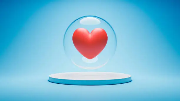 Photo of Crystal sphere surrounding a red heart on blue background. Love isolation, preciousness, uniqueness concept.