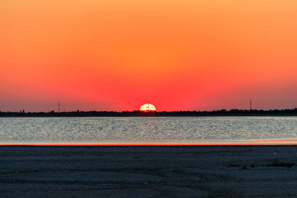 istock Beautiful orange sunset over a salt lake 1363575608