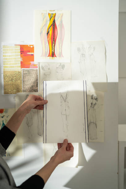 istock Female tailor putting her drawings on wall 1363576326