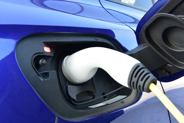 istock Connected charging connector to electric car. 1363577437