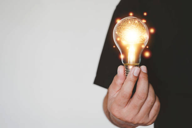 istock Brain inside the hands of the businessman background. Brain Nervous System concept, Creative The brain in the light bulb, The concept of the business idea. 1363578302