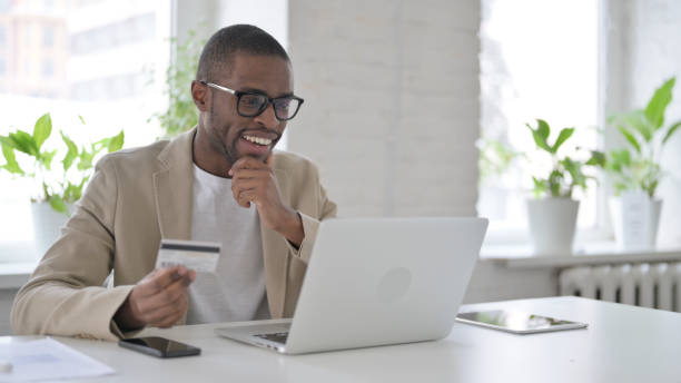 istock African Man making Successful Online Payment on Laptop 1363579827