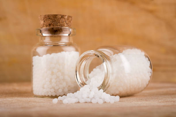 istock Homeopathy globules in glas bottles on a table 1363579848