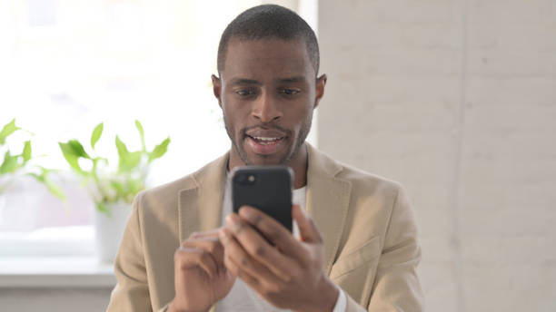 istock Portrait of African Man using Smartphone 1363580731