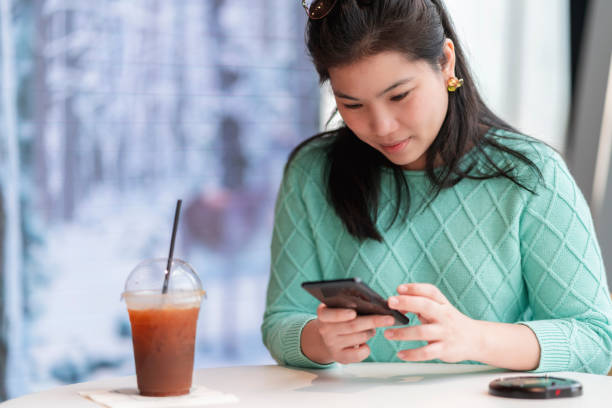 istock attractive smart casual asian female hand typing chat using smartphone telecommunication positive attitude smile in cafe casual,smart business owner entrepreneur working with smartphone in cafe 1363581017