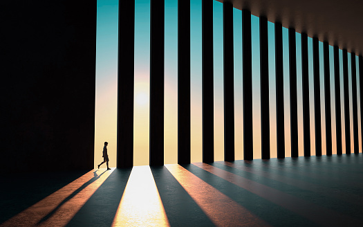 Man walks in a business hall with columns during sunset . This is a 3d render illustration .