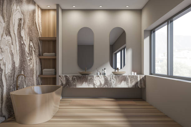 istock Dark bathroom interior with two sinks, bathtub, oval mirrors, window 1363583903
