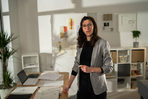 istock Female atelier standing in studio while holding pencils in hand 1363584130