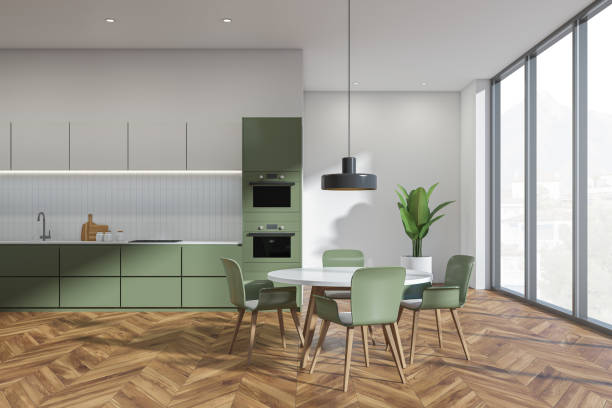 istock White and green kitchen interior with table and chairs, parquet floor and window 1363584932