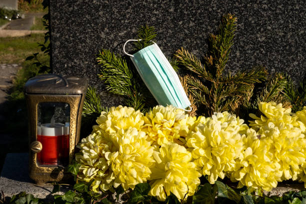 istock Face mask next to a candle in the cemetery 1363585437