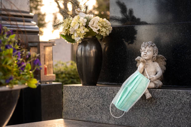 istock Disposable surgical face mask on a grave. 1363585438