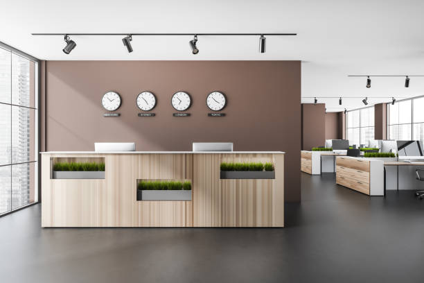 istock Reception interior desk with computers and clocks, coworking near window 1363586282